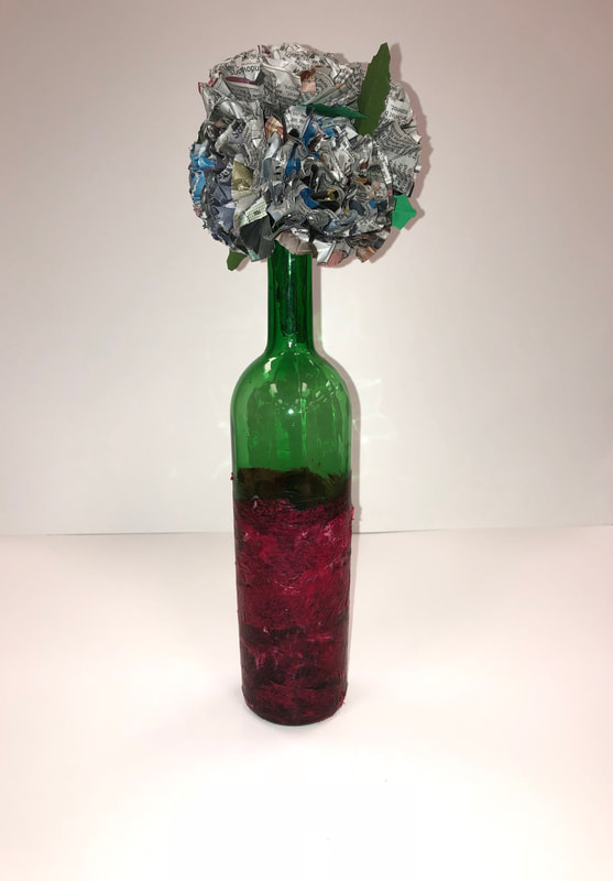 Paper flowers inside of wine bottle